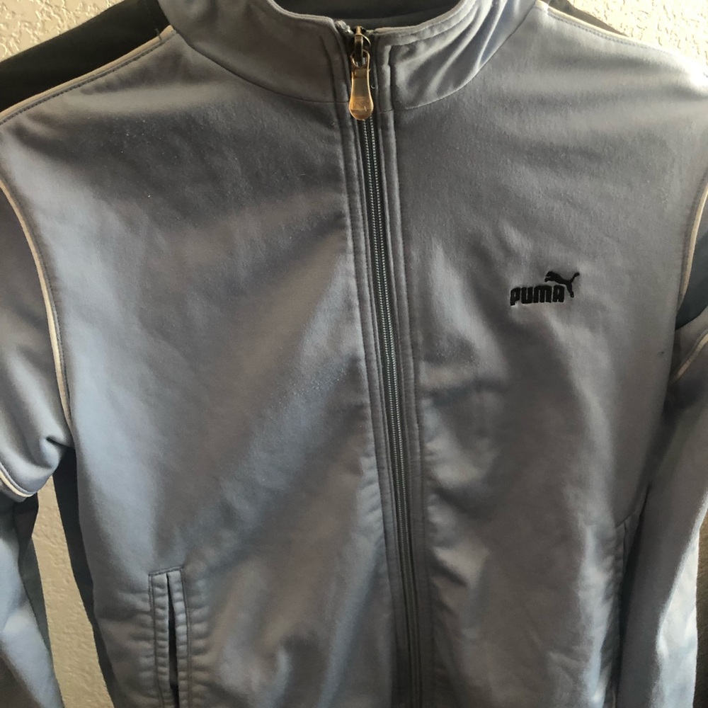 A Puma baby blue with black strips track jacket